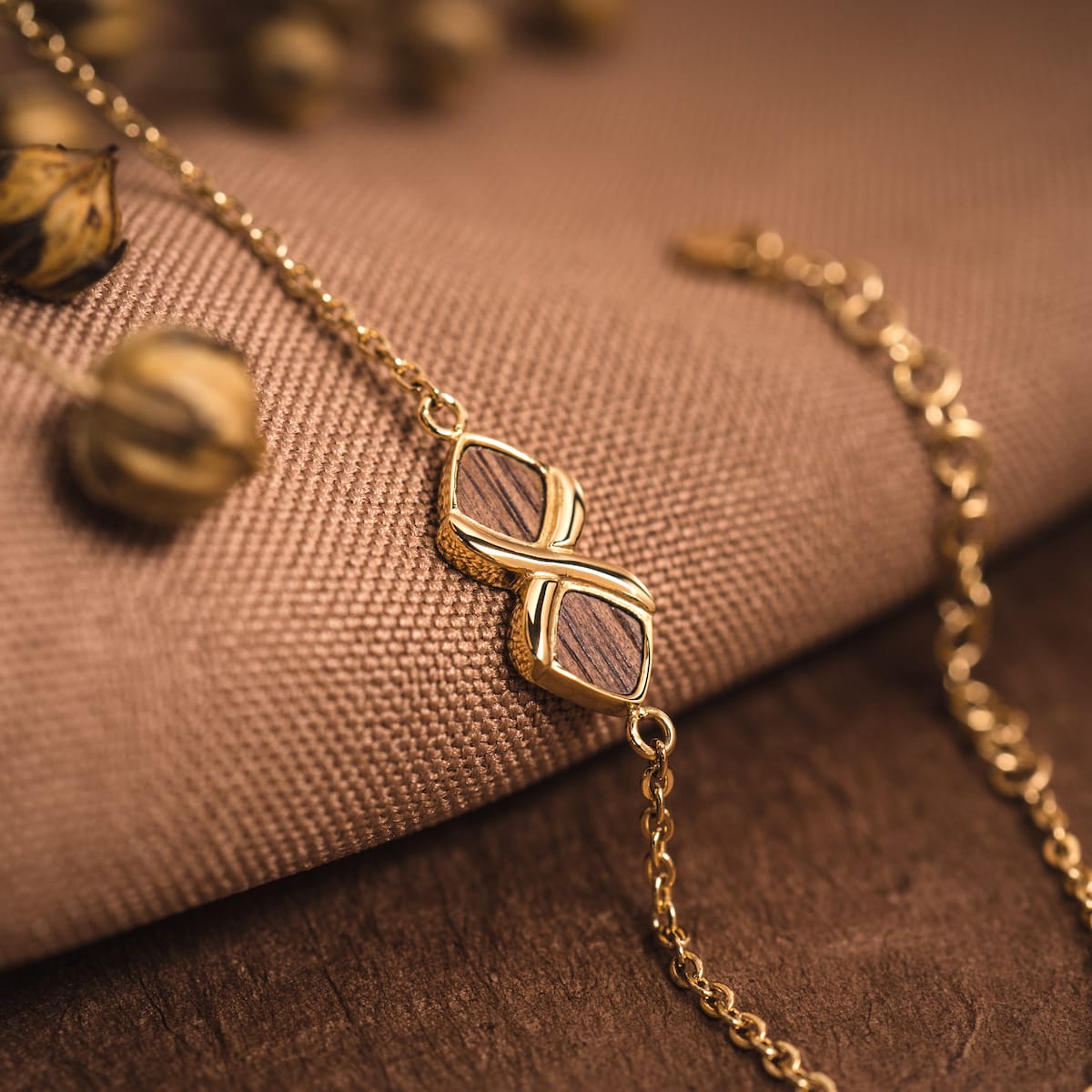 "Mosaic Bracelet", a bracelet featuring elegant walnut and gold accents in a mosaic design.