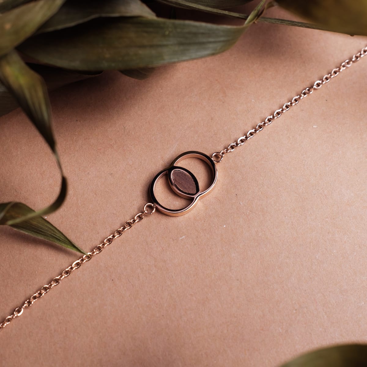 "Effigy Bracelet" bracelet with elegant walnut and rose gold accents on a natural background.