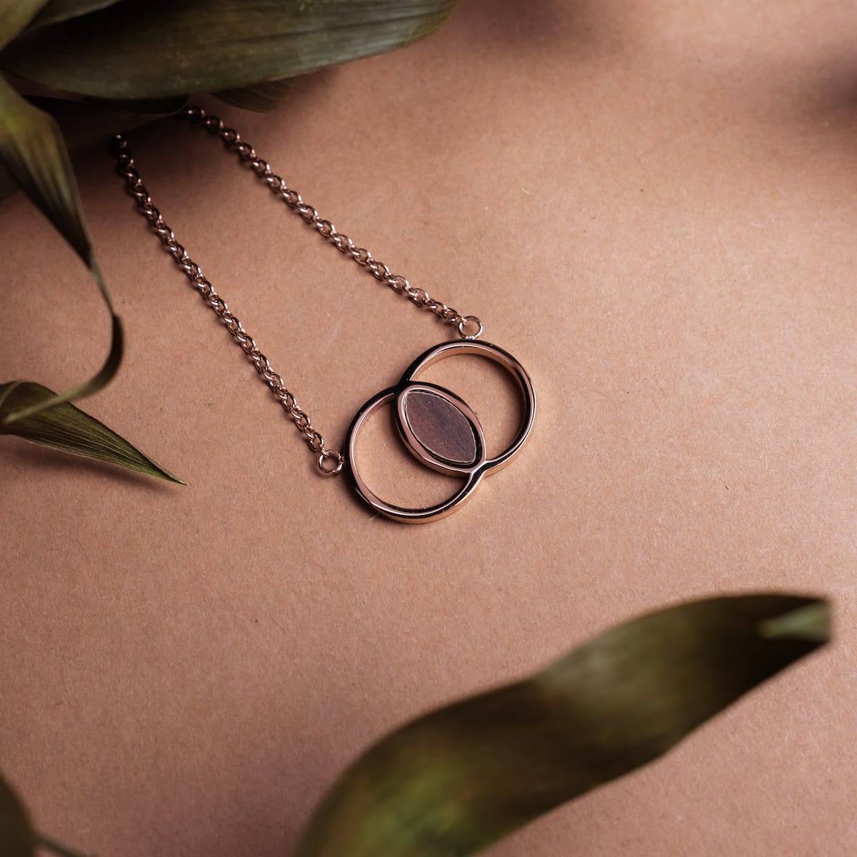 "Effigy Necklace" necklace, featuring walnut and rose gold, showcasing an elegant and modern design.