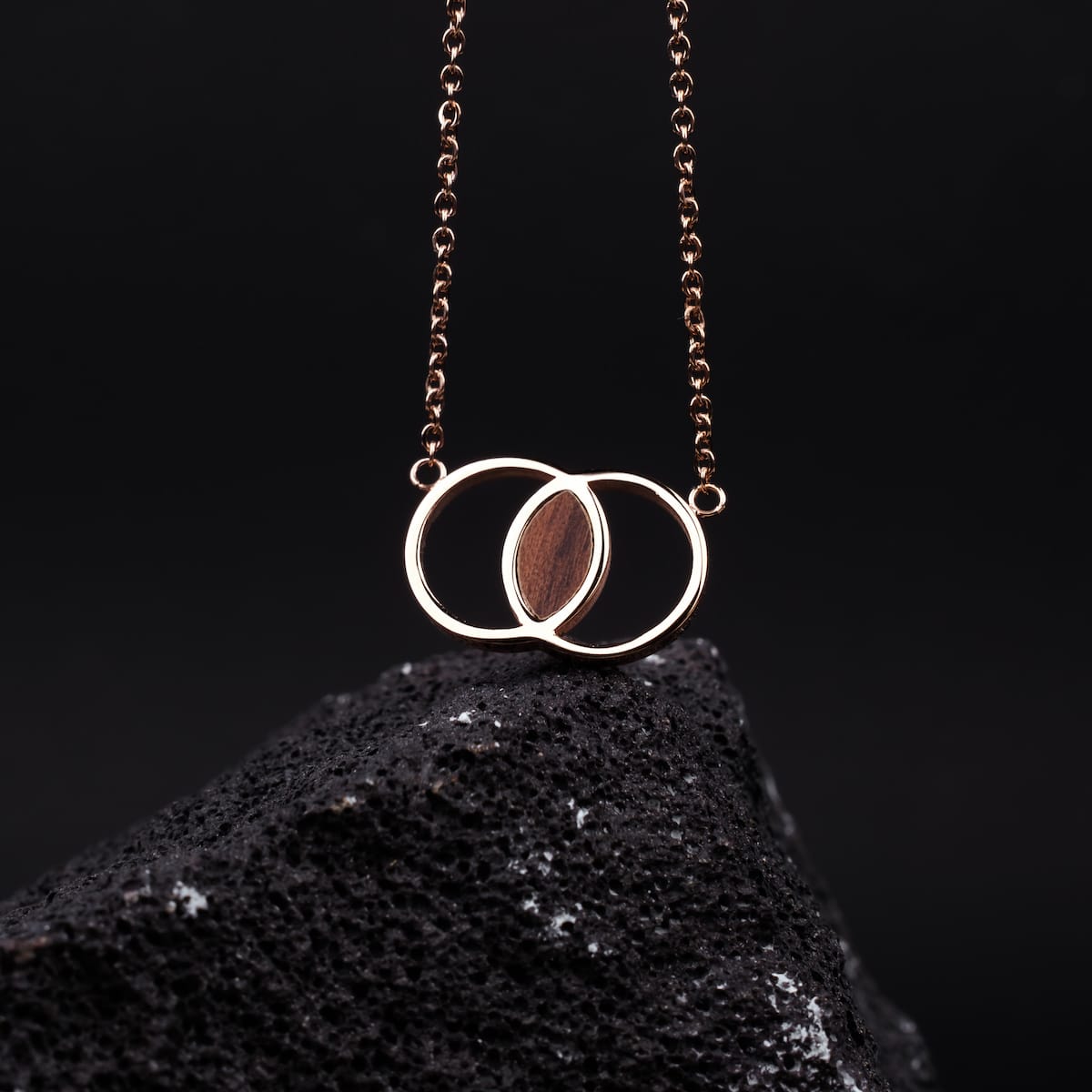 "Effigy Necklace" necklace featuring a walnut and rose gold design with a modern, elegant style.