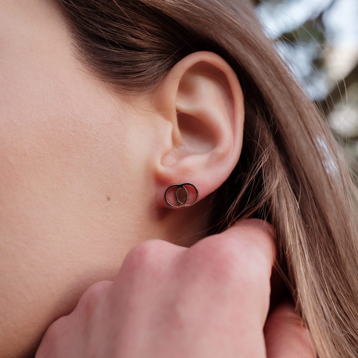 Effigy earrings feature a Walnut and Rose gold design, showcasing a modern, stylish look.