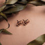 "Effigy Earrings" stud earrings in Walnut and Rose gold with a minimalist design.