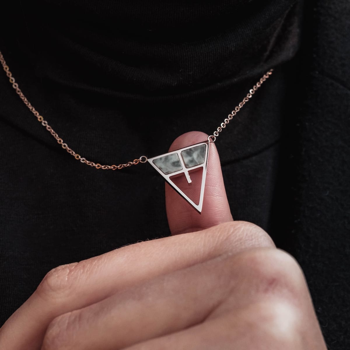 "Chiaroscuro Necklace necklace featuring a gray marble and rose gold triangle pendant style."