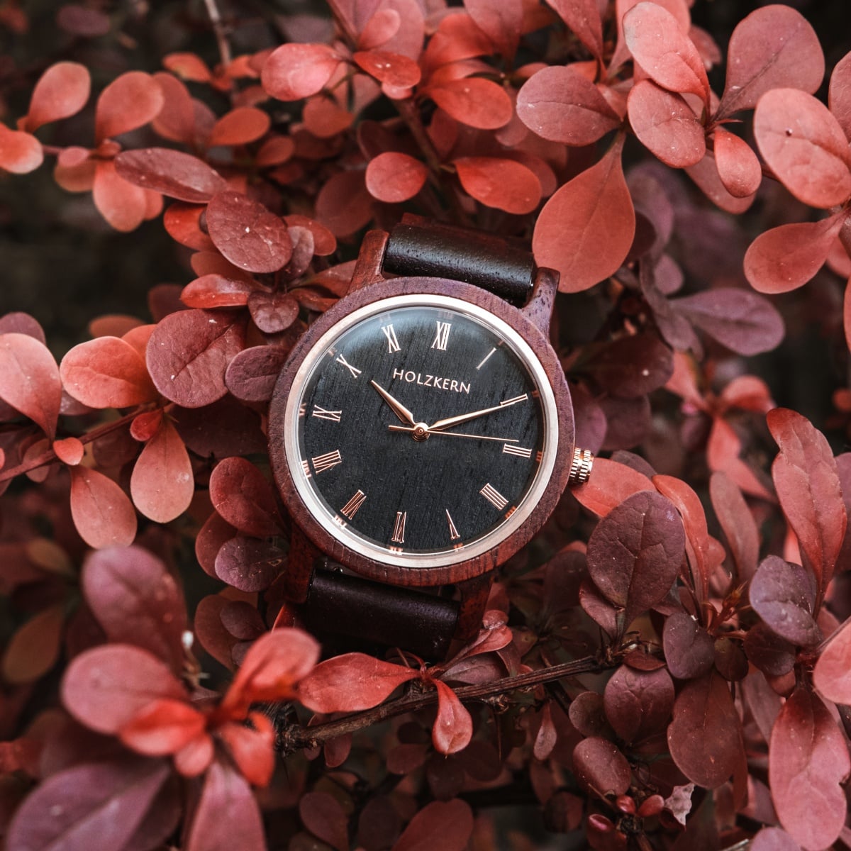 "Passion" watch with Padauk and Maple materials, featuring a classic design set against a backdrop of vibrant red leaves.