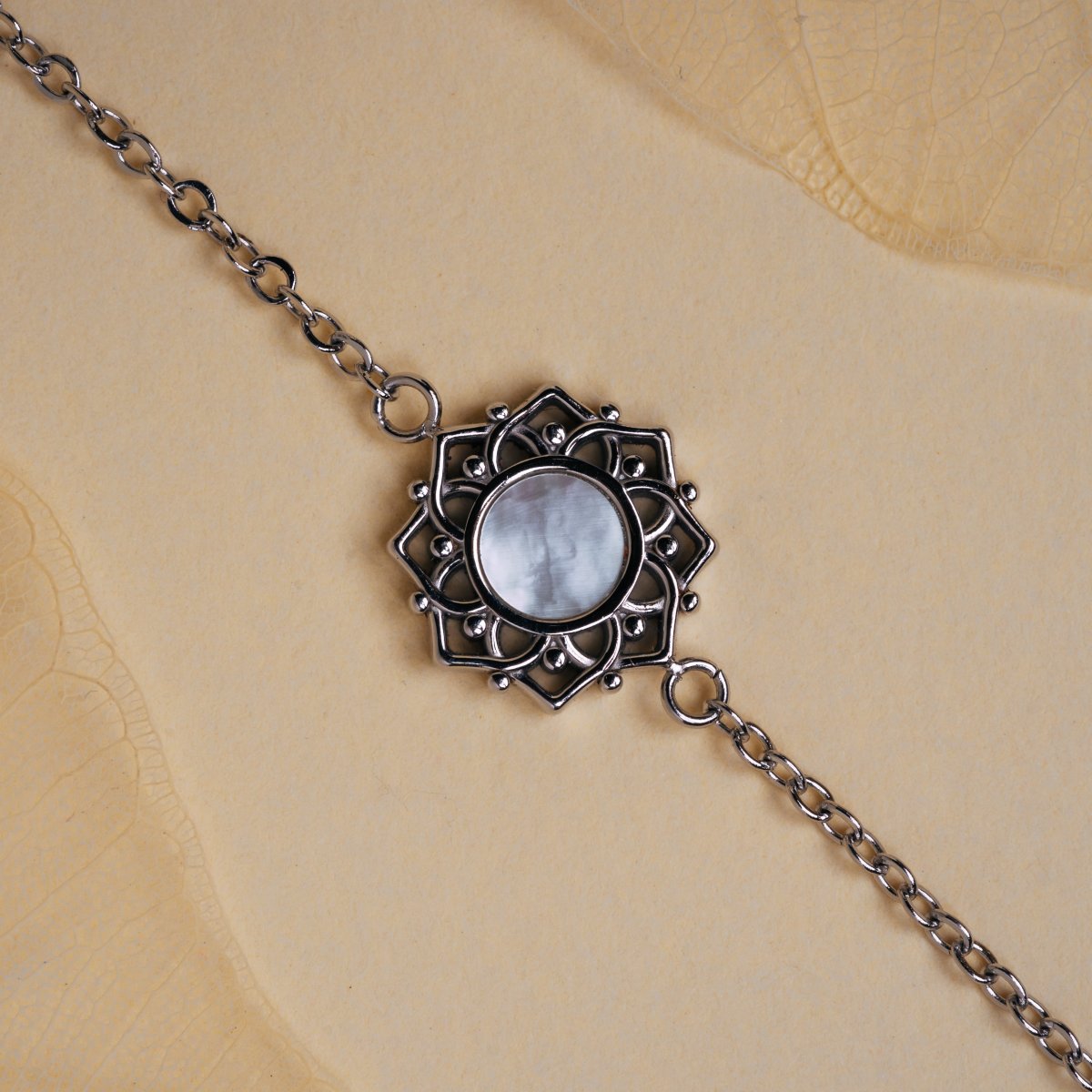 "Composition Bracelet" bracelet, featuring white nacre and silver, with an elegant, intricate design.