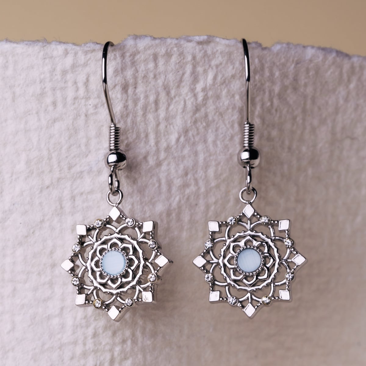 "Aphonia Earrings" earrings feature aquamarine and silver in an intricate, geometric design.