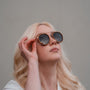 "The Enchanting" sunglasses in cinnamon wood and matte gold, featuring a stylish and modern design.