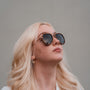 "The Honorable" sunglasses featuring a sleek teak frame and matte gold accents in a stylish modern design.