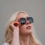 "The Prominent", stylish sunglasses with a square frame in maple and dark grey tones.