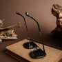 "The Prominent" sunglasses in maple and dark grey with a stylish, sleek design, displayed on a book.