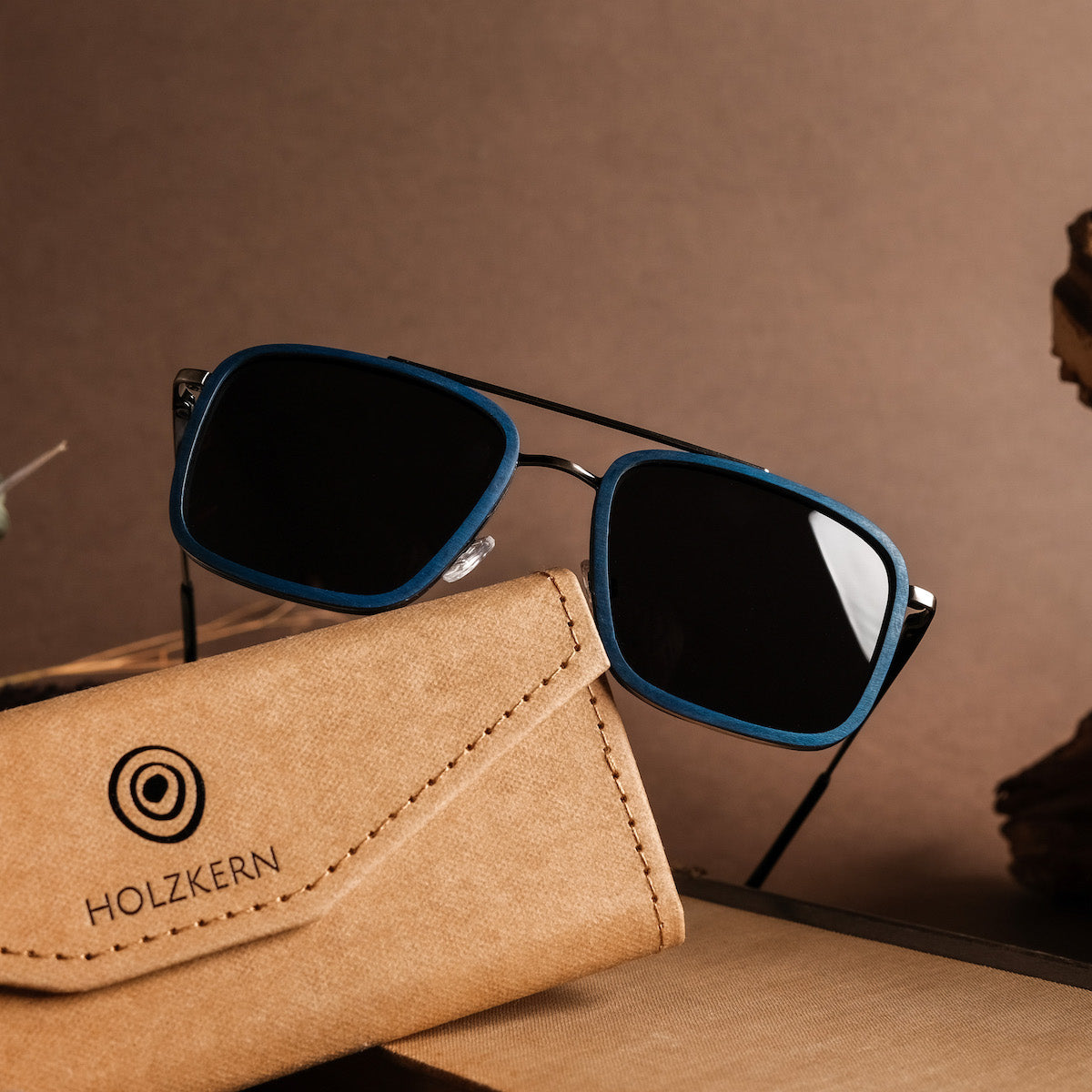 "The Prominent" sunglasses featuring a sleek maple and dark grey design with a stylish rectangular frame.