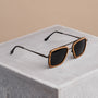 "The Logician" sunglasses featuring a zebrawood frame and dark grey lenses on a concrete surface.