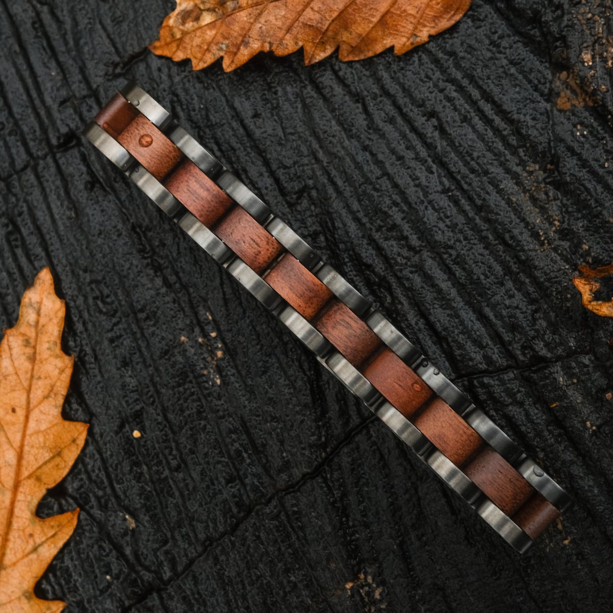 "Triad" knife with a walnut and gray finish, featuring a sleek and natural design.