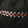 "Triad" bracelet, featuring a sleek walnut and silver design.