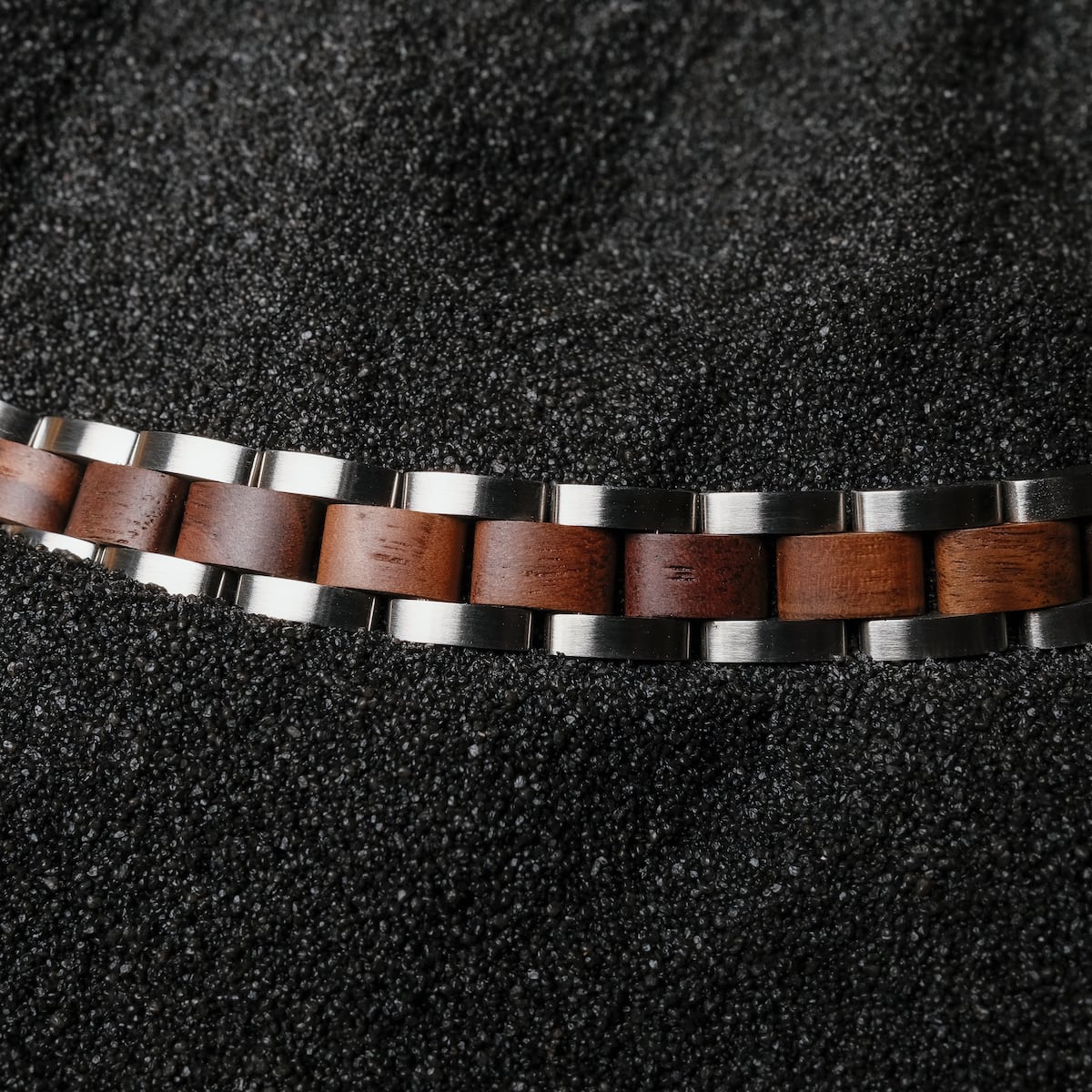 "Triad" bracelet, featuring a sleek walnut and silver design.