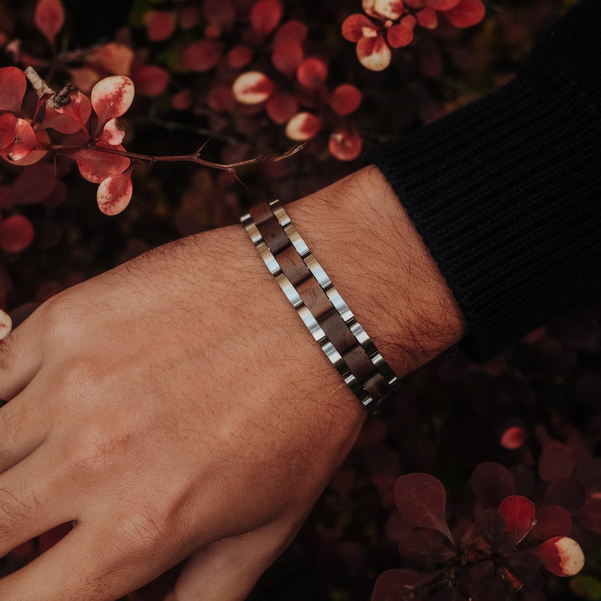 "Triad" bracelet featuring a modern design with walnut and silver tones.