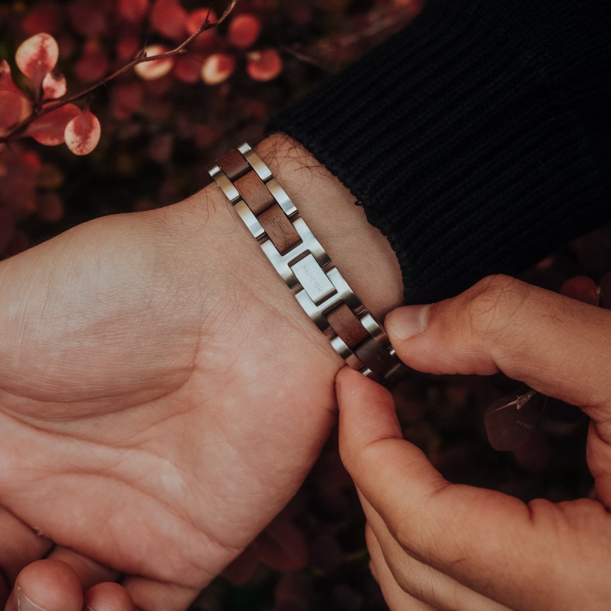 "Triad" bracelet featuring a sleek walnut and silver design.