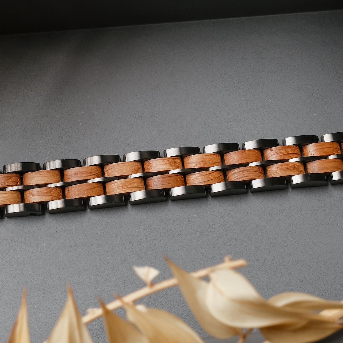 "Kanon" bracelet features oak and gray hues with a modern, woven design.