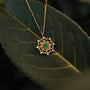 "Aphonia Necklace": Elegant green marble and gold necklace with intricate design.