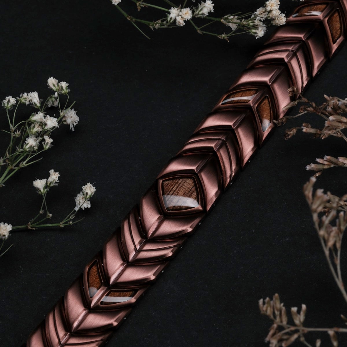 "Prelude", a bracelet with walnut and copper elements, showcasing a sleek and elegant design.