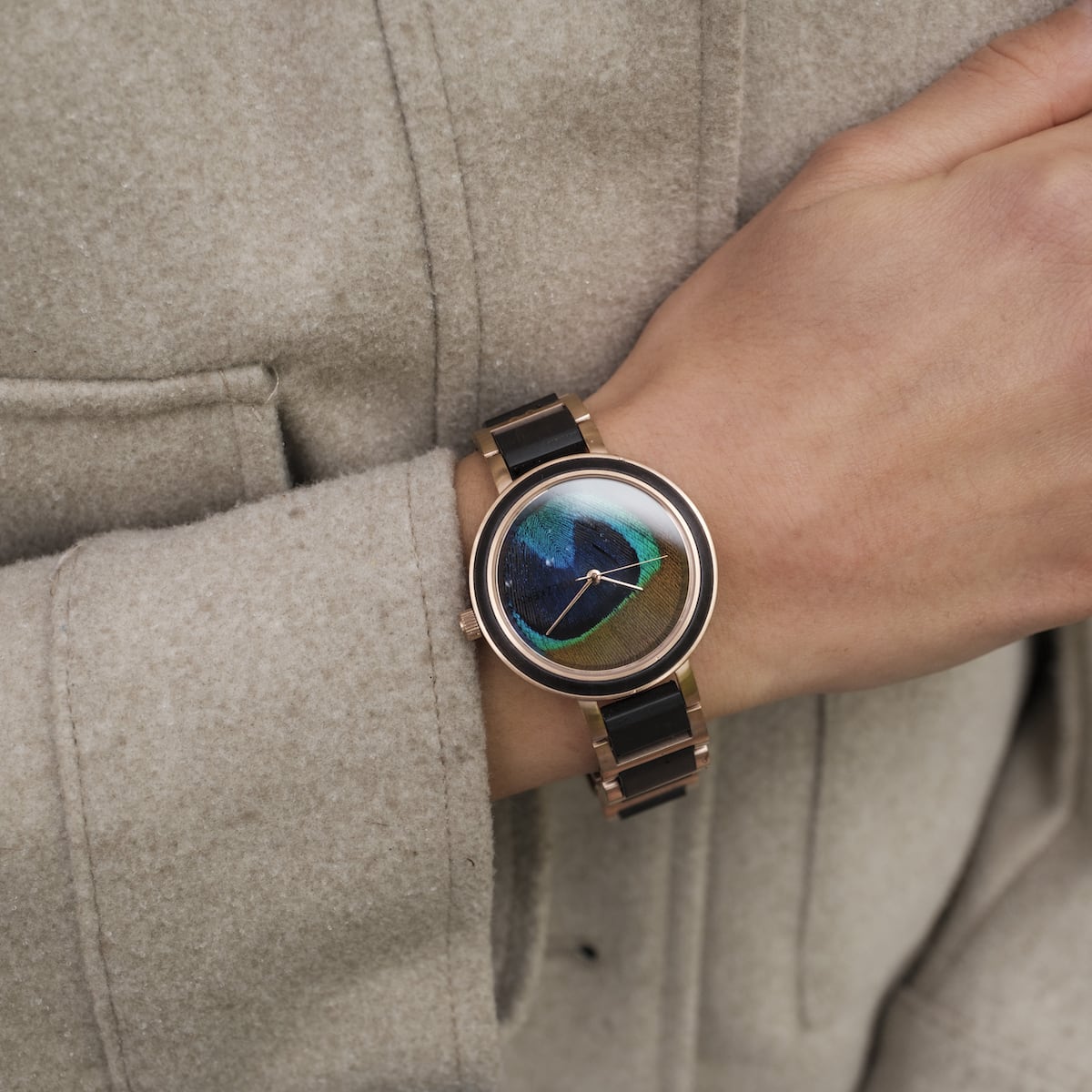 "The Fearless" wristwatch featuring a maple and peacock feather design, showcasing an elegant and vibrant visual style.