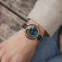 "The Fearless", a stylish watch featuring maple accents and a striking peacock feather design.