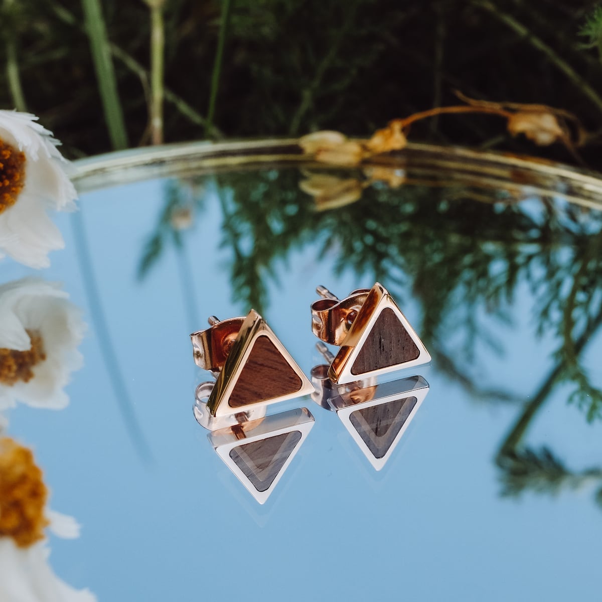 "Scale Earrings": Elegant triangular walnut and rose gold earrings reflecting natural beauty.