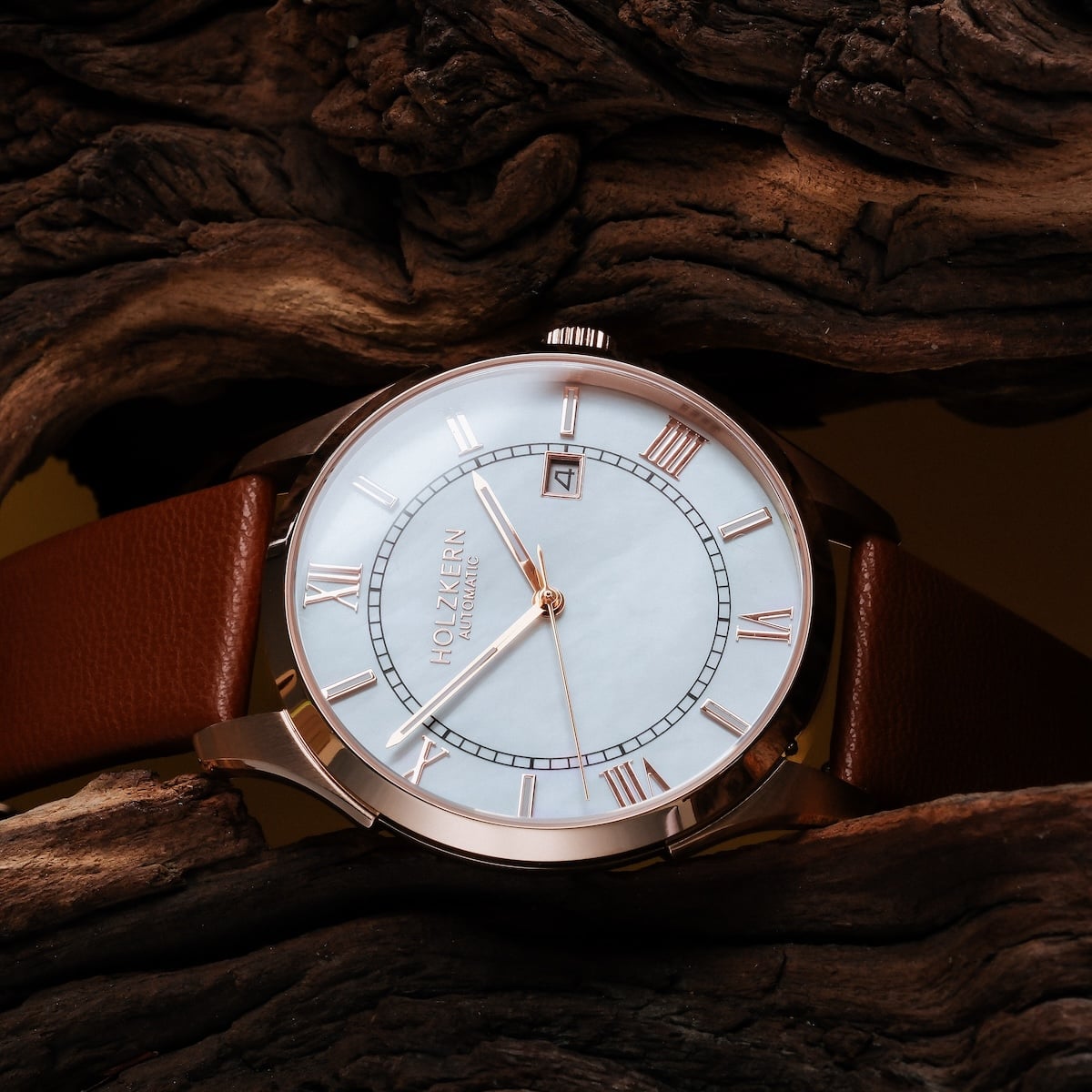 "Milestones" watch featuring a nacre dial and brown strap, showcasing a classic, elegant design.