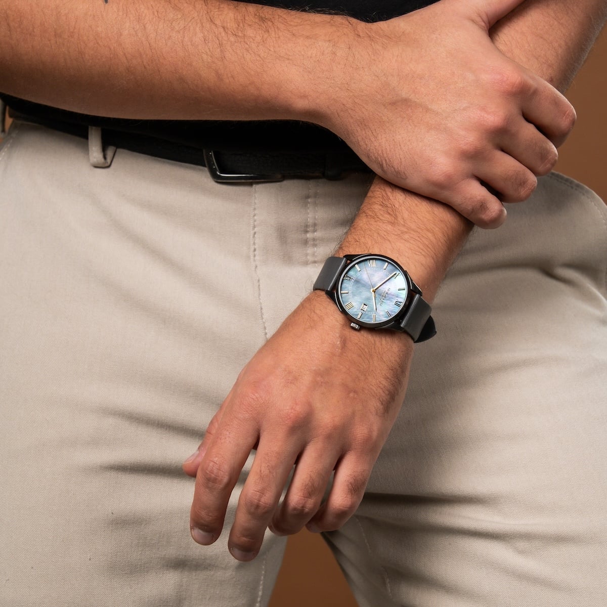 "Milestones" watch with a nacre face and dark gray band, showcasing an elegant and modern design.