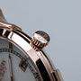 "Milestones" wristwatch, featuring a nacre dial and brown accents with an elegant rose gold finish.