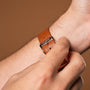 "Milestones" watch with a brown leather strap and nacre accents, showcasing stylish and elegant design elements.