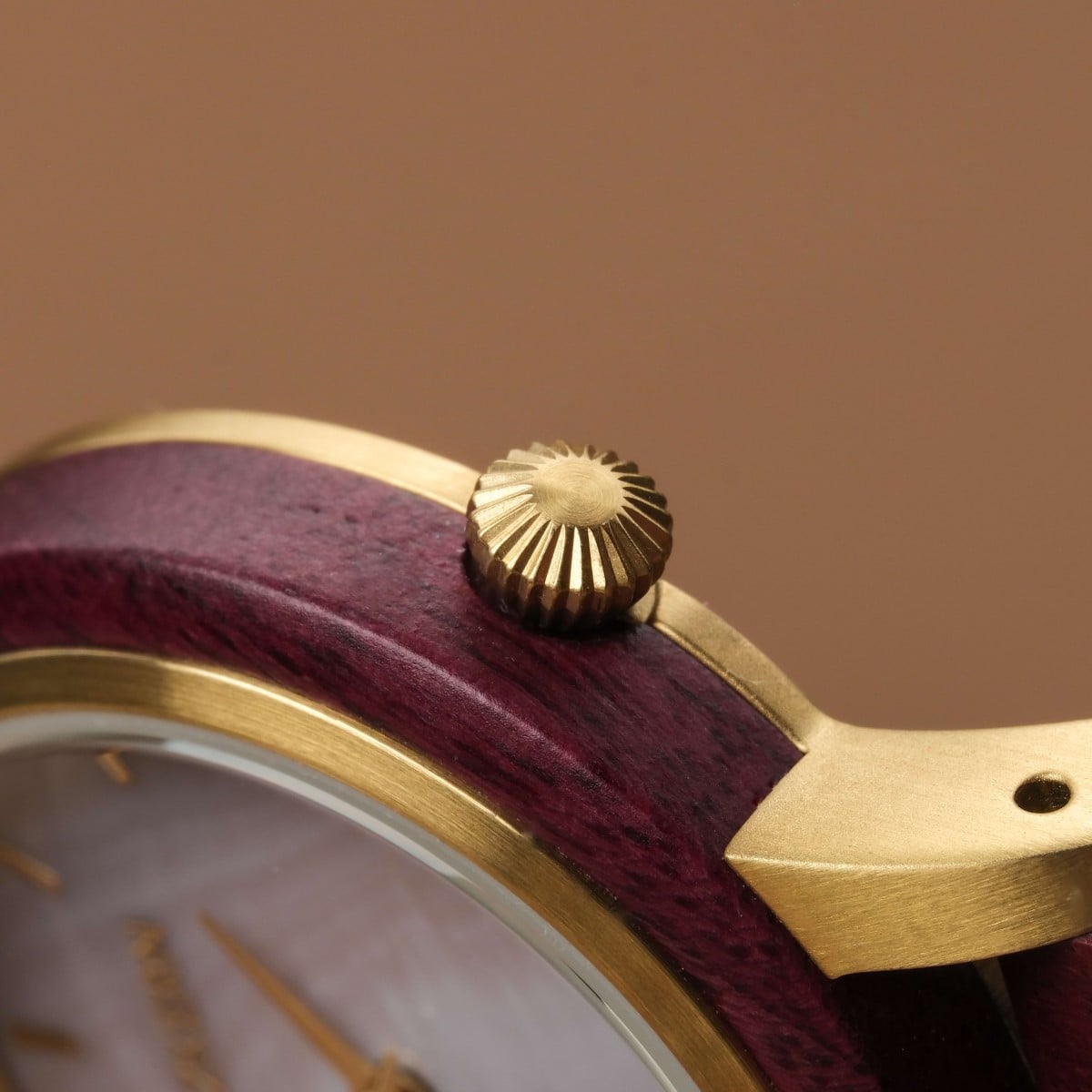 "Napali" watch featuring an elegant amaranth and nacre design with a detailed gold-tone bezel.