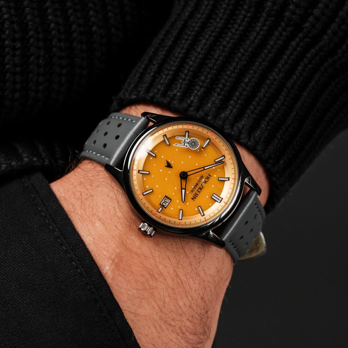 "NCC-1701" wristwatch with a jade/dark grey strap and vibrant orange dial.