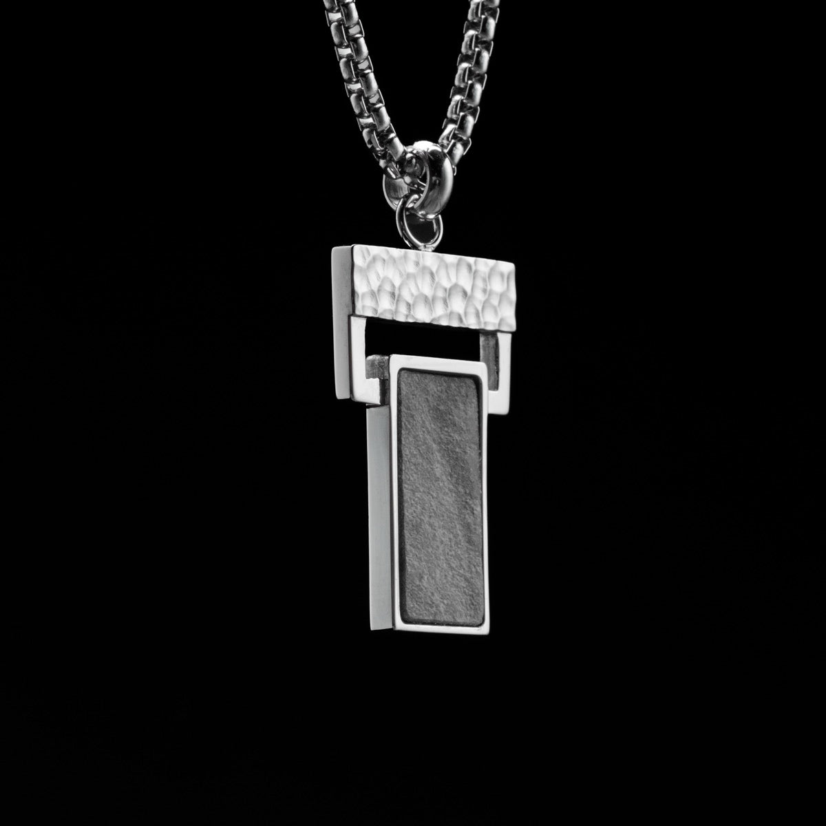 "Transcendent" pendant featuring a modern geometric design in slate and silver.