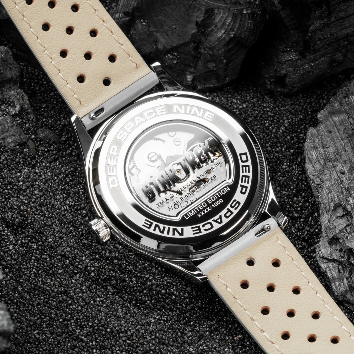 "DS9", a stylish watch with a marble and light gray design, featuring a sleek metallic finish and leather strap.