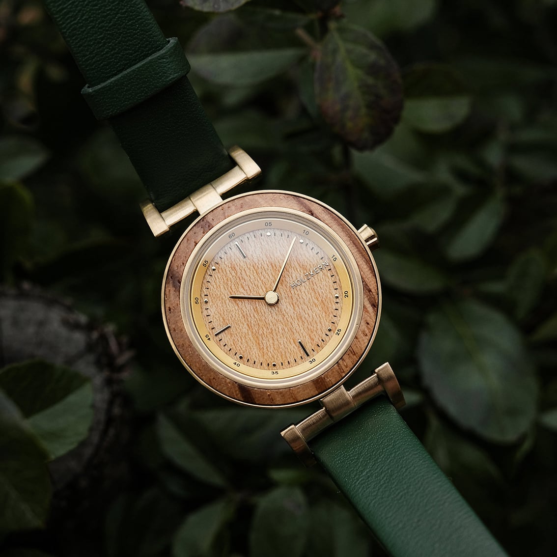 "Laura", a stylish watch with Zebrawood and Oak detailing, featuring a green leather strap.
