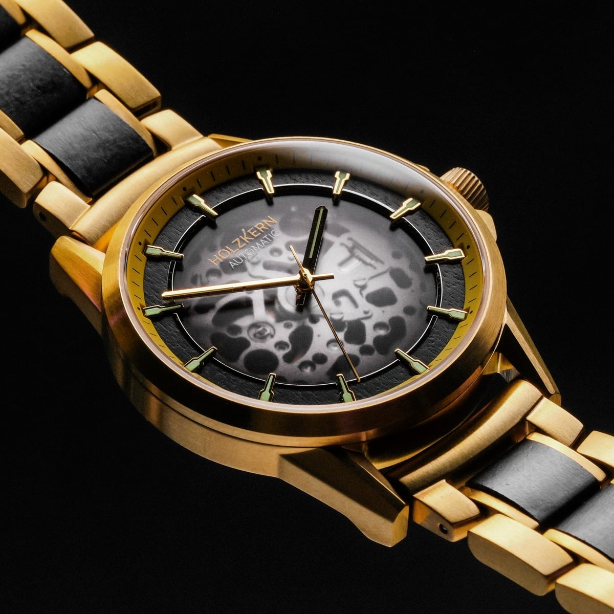 "Flowfinder" wristwatch, featuring a gold and maple design with a stylish patterned dial and metallic band.