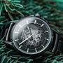 "Flowfinder", a stylish watch in maple and dark gray, featuring an intricate dial design.