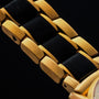 "Flowfinder" watch with a maple and gold design, featuring sleek, contrasting links.