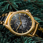 "Flowfinder" watch featuring maple and gold materials with a sleek, classic design.