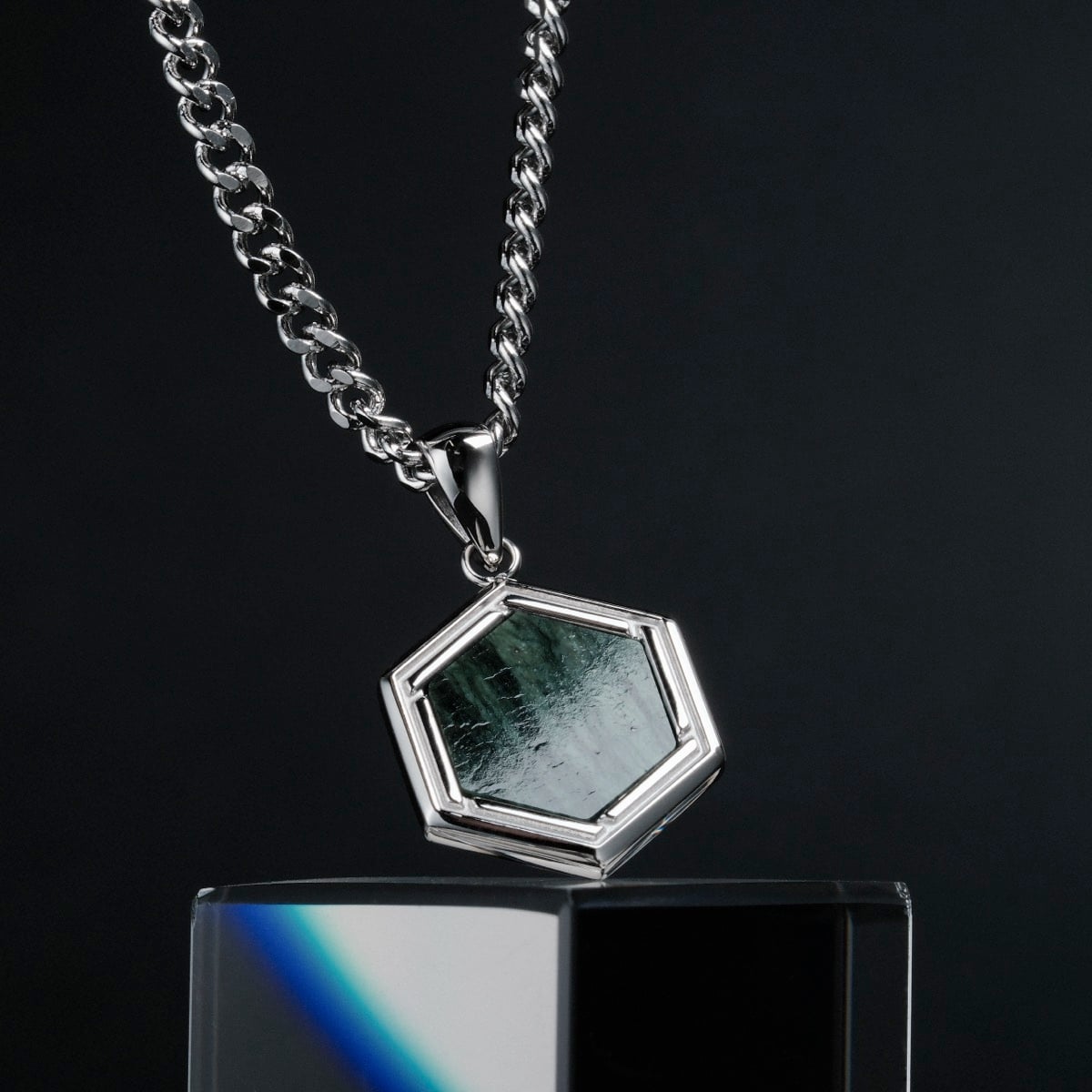 "Axis Necklace" - A hexagonal silver necklace featuring a green marble pendant with a modern, sleek style.