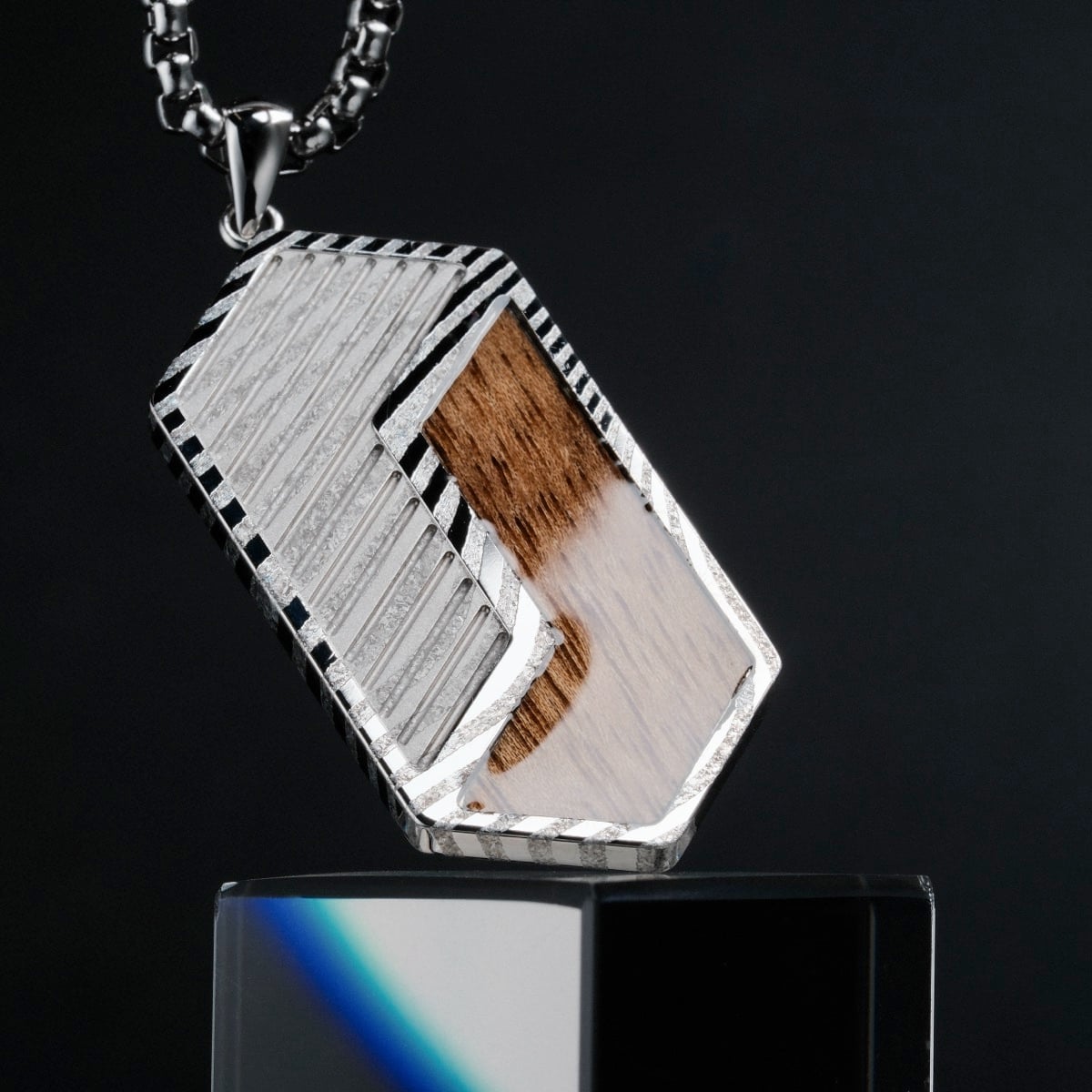 "Zigzag Necklace" is a bold necklace featuring a zigzag design with Koa wood and Damascus steel, offering a modern, stylish look.