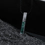 "Campania Necklace" necklace featuring a vertical design with green marble and Damascus steel, exuding a modern elegance.