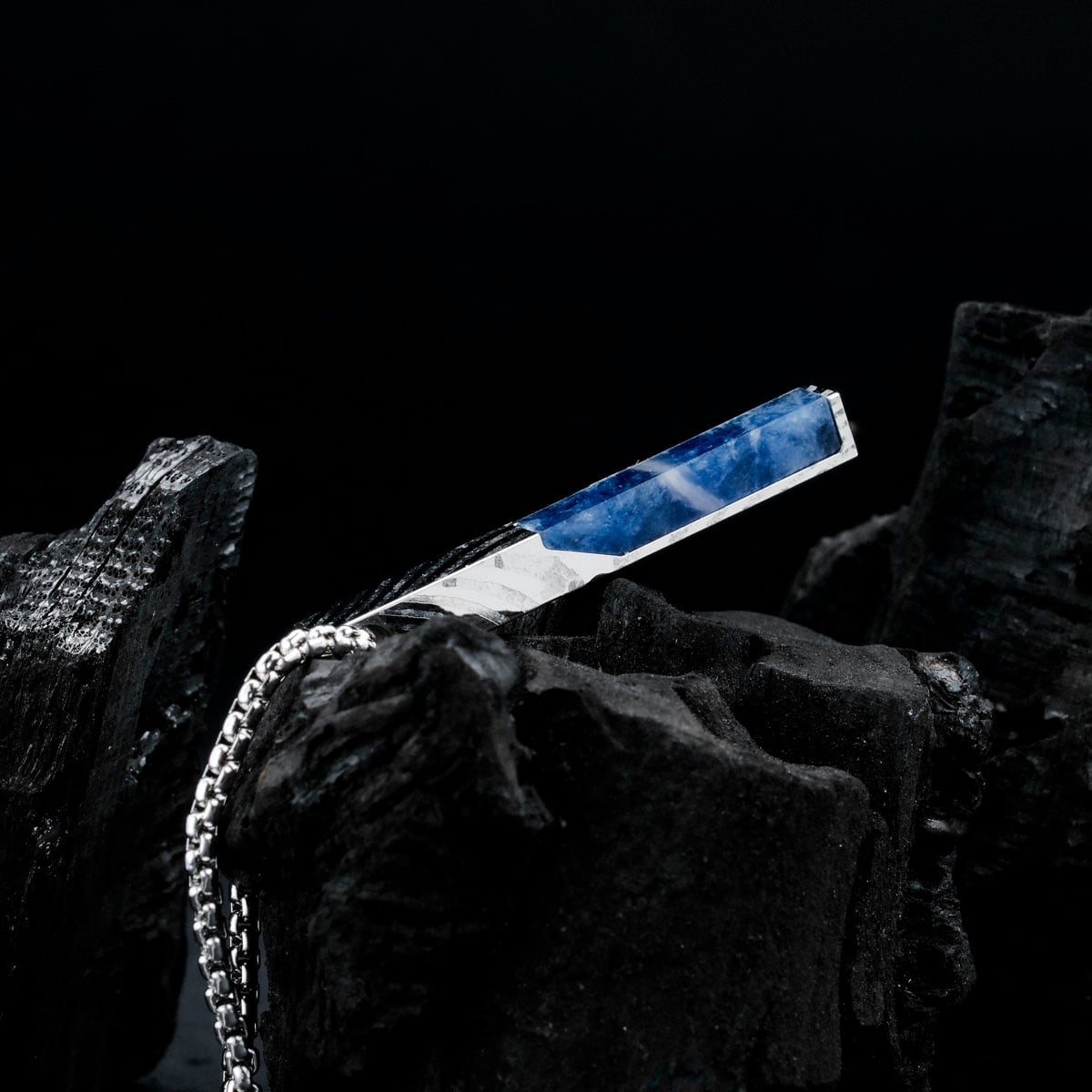 "Campania Necklace" necklace featuring a sleek Sodalite and Damascus design against a dark background.