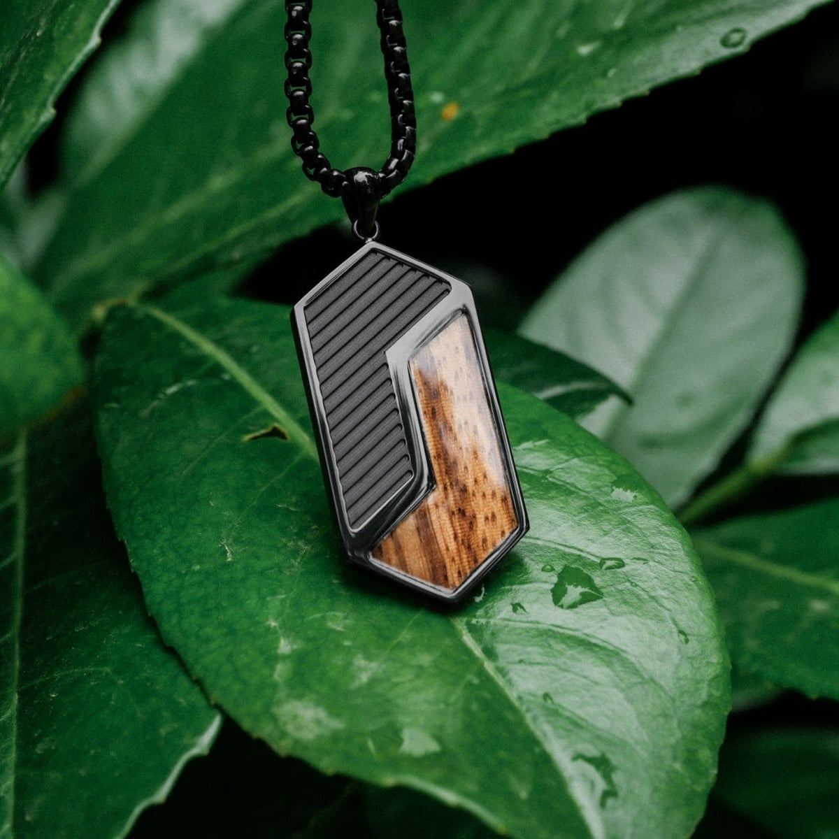 "Zigzag Necklace", a geometric necklace crafted from zebrawood and black materials, with a sleek modern design.