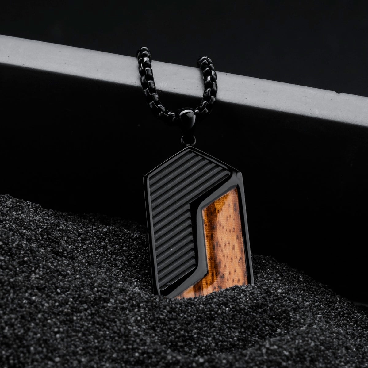 "Zigzag Necklace", a zebrawood and black necklace, showcases a bold, geometric design with contrasting textures.