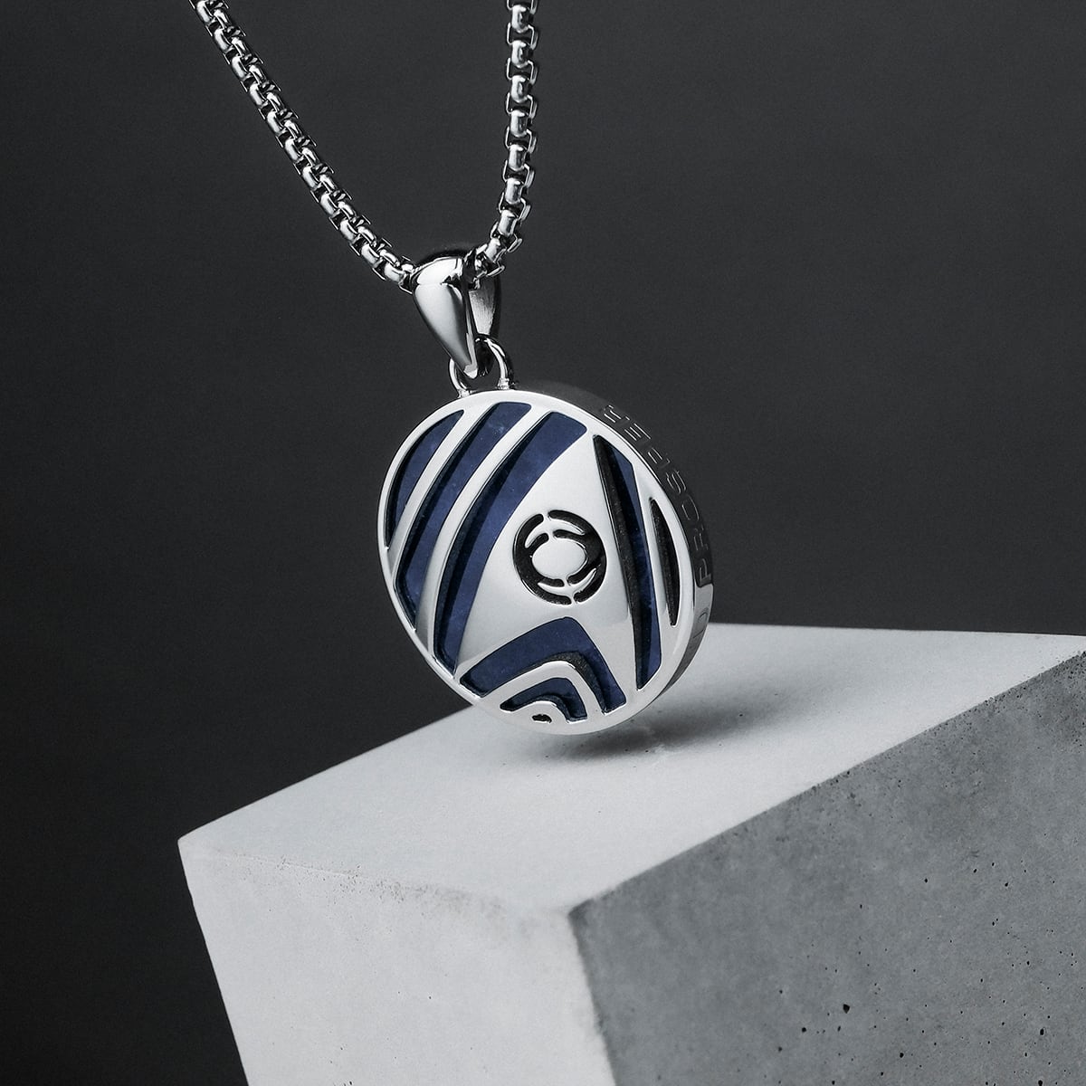 "Sciences Necklace" necklace featuring a silver and sodalite pendant with a modern geometric design.
