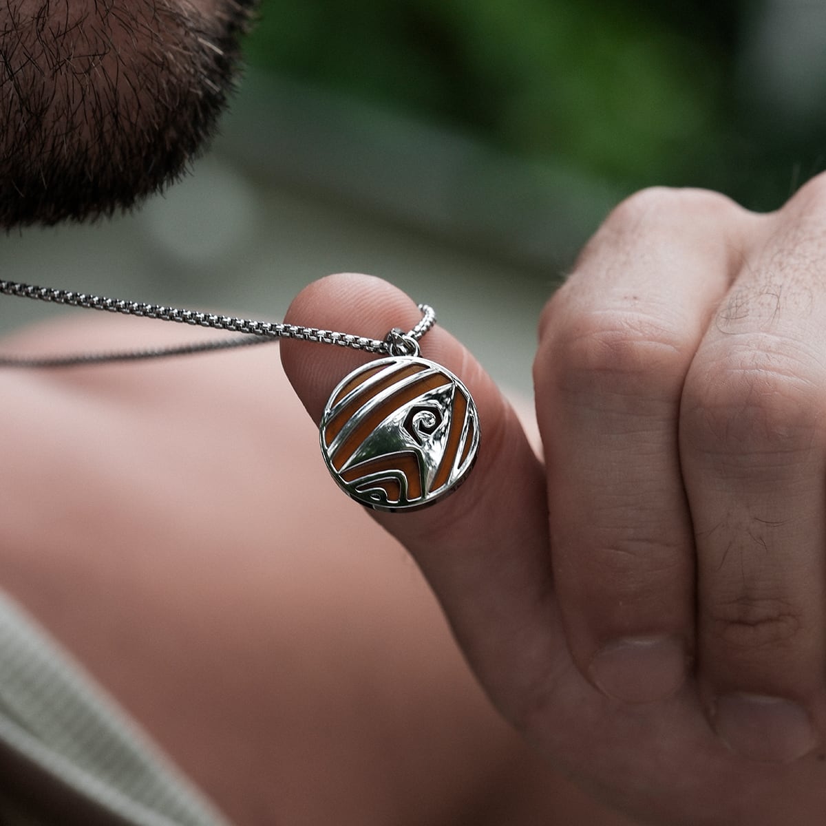 "Operations Necklace", a stylish jasper and silver necklace, features an intricate circular design.