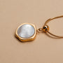 "Charms Bracelet", gold charms bracelet featuring a modern, elegant style with a pearl-like pendant.