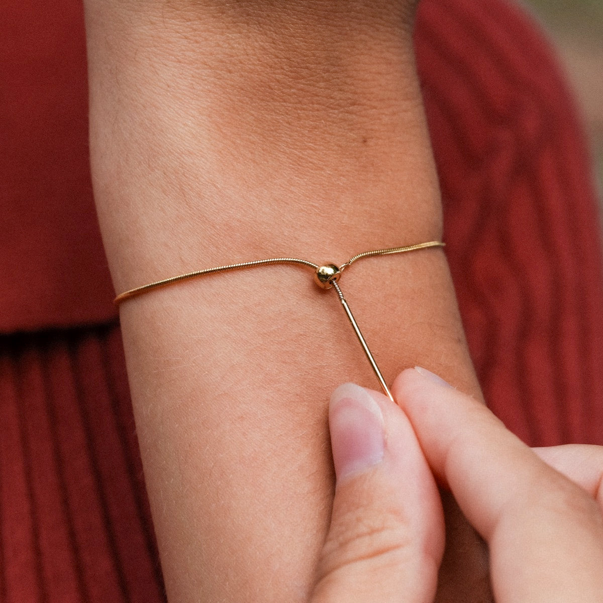 "Charms Necklace": A delicate gold necklace with minimalist charm style.